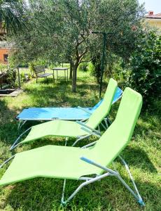 dos sillas de jardín sentadas en el césped en Olea apartments, en Pobegi