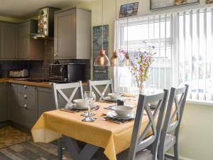 a kitchen with a table with chairs around it at Seaside Dreams in Bessingby