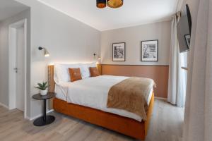 Postel nebo postele na pokoji v ubytování Living Ascona Boutique Hotel