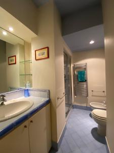 a bathroom with a sink and a toilet at Casa vela in Turin