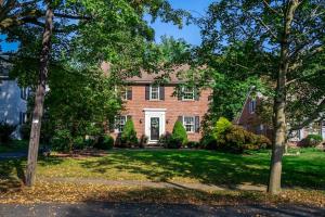 a brick house with trees in front of it at Beautiful fully-furnished Colonial in Millersville in Millersville