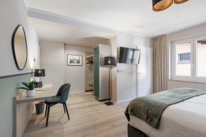 a hotel room with a bed and a desk and a mirror at Living Ascona Boutique Hotel in Ascona