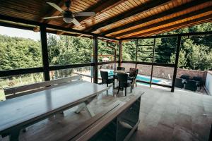 a large screened in porch with a table and chairs at Vila Odmor 