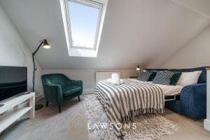 1 dormitorio con 1 cama, TV y silla en Loft Living by Lawsons en Windsor