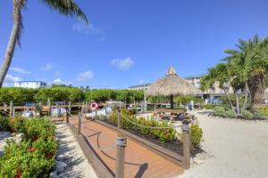 a resort with a beach with palm trees and a resort at 1206 Ocean Pointe in Tavernier