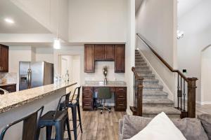 a kitchen with a counter and a staircase in a house at City Getaway Yard Bbq Games Wifi Pets Ok in Houston
