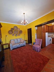 een woonkamer met een bank en een stoel bij Casa do Avô Lopes in Tomar
