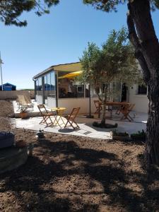 a group of chairs and tables on a patio at Huitres et mer in Marennes