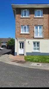 a brick house with a white door on a street at Cozy Room,Private Bathroom,Private Kitchynete in Dublin