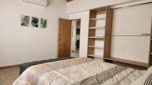 Un dormitorio con una cama y un frigorífico. en Caminos del vino !!!!, en Coquimbito