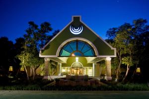 a house with a gambrel roof at night at Southern Sun Bloemfontein in Bloemfontein