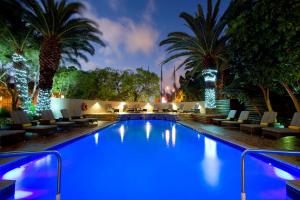 a pool with blue lighting in a resort at night at SunSquare Cape Town Gardens in Cape Town
