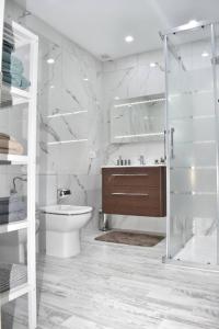 a bathroom with a shower and a toilet and a sink at Ke Casetta Tenerife Anna Apartment in Adeje