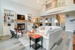 a living room with a white couch and a fireplace at Expansive Georgetown Home with Decks and Fire Pit! in Georgetown