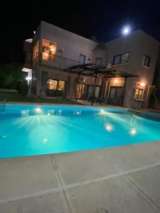 a swimming pool in front of a house at night at Bahga villa in Alexandria