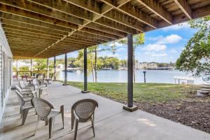 a porch with chairs and a view of the water at The Lodge at Sparkling Water in Sunrise Beach