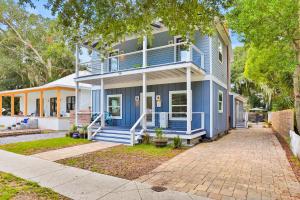a blue house with a porch and a driveway at Sanford Serenity in St. Augustine