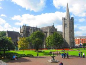 a large building with a clock tower in a park at Cosy Cottage in the City in Dublin