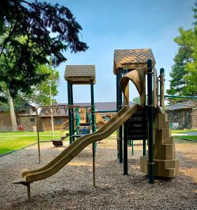 a playground with a slide in a park at Park Place - The Boardwalk 112-B in Darby