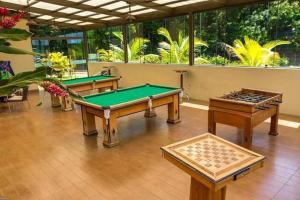 three billiard tables in a room with windows at Caldas Novas Aldeia do Lago in Caldas Novas