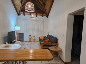 a living room with a table and a couch at Ventanas de la Patagonia 2 in Esquel