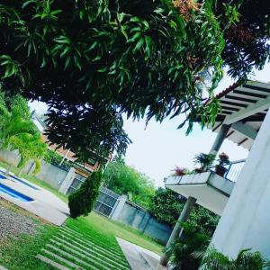 a stairway leading up to a house with trees and a building at Cabaña Milan in Aguachica