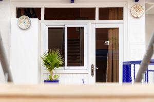 a front door of a house with a potted plant at The Rina Hostel in Agadir