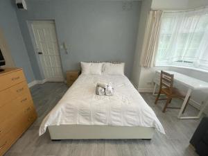 een slaapkamer met een bed met twee knuffels erop bij New Studio on Golders Green RD in Londen
