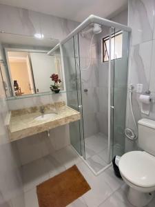 a bathroom with a shower and a toilet and a sink at Apartamento Dei Fiori in Guaramiranga