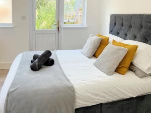 a large bed with two stuffed animals on it at Minet Gardens Central - Suite 3 in London