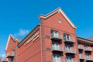 a red brick building with a clock on it at Courtyard by Marriott Holland Downtown in Holland