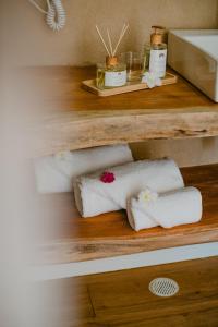 a bunch of towels on a shelf in a bathroom at Dolphin Hotel in Fernando de Noronha