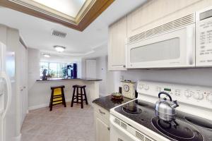 a kitchen with a sink and a stove top oven at Lighthouse Towers #206 in Clearwater Beach