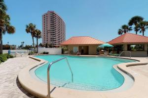 a swimming pool at a resort with a building at Lighthouse Towers #206 in Clearwater Beach