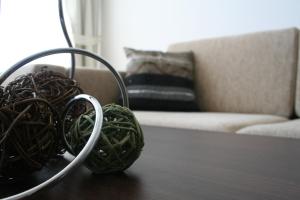 a table with baskets on top of a table with a couch at Apartments Helios in Pomorie