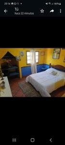 a picture of a bedroom with a bed and a desk at LA ESTANCIA HOSTEL COLONIA in Colonia del Sacramento