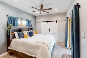 a bedroom with a large bed and a ceiling fan at Nancy's Retreat in Eugene