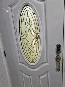 a door with a stained glass window on it at S.G Apartment Complex. in Linstead