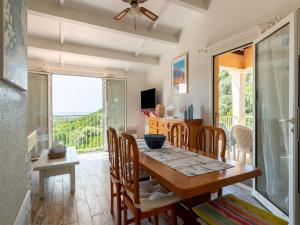 a dining room with a table and chairs and a window at Apartment near Saint Tropez Beach in Roquebrune-sur-Argens