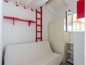 a room with a bed and a ladder on the wall at Apartment near Saint Tropez Beach in Roquebrune-sur-Argens +32 photos