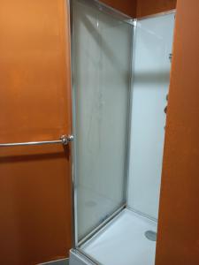 a shower stall with a glass door in a bathroom at 1A chambre confortable 02 in Audun-le-Tiche