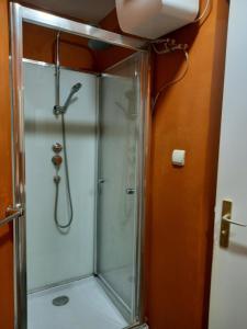 a shower in a bathroom with a glass shower stall at 1A chambre confortable 02 in Audun-le-Tiche