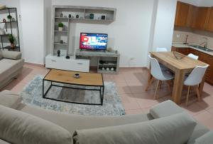 a living room with a couch and a table at CALM Blue Sea in Durrës