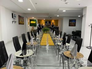 a long dining room with a long table with wine glasses at Hotel Business Center in Popayan