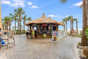 a food stand on the beach with palm trees at Calypso Resort Serenity 1 in Panama City Beach