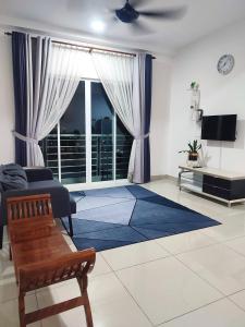 a living room with a large window and a couch at KAF Homestay for Musliim only with Pool, 3 Bedroom, Smartkey concept, Kids Trampoline, Game console, WIFI, Durioo in Perai