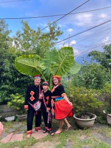 a group of people standing in front of a plant at Eco Joville House - Sapa Homestay in Sa Pa