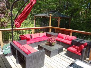 a deck with couches and a gazebo at Fireside - Waterfront Resort Style Executive Cottage in Kawartha Lakes