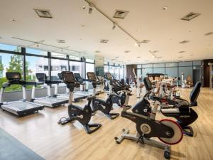 einen Fitnessraum mit Laufbändern und Crosstrainern in der Unterkunft Grand Prince Hotel Osaka Bay in Osaka