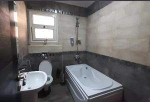 a bathroom with a white toilet and a sink at the house in Cairo